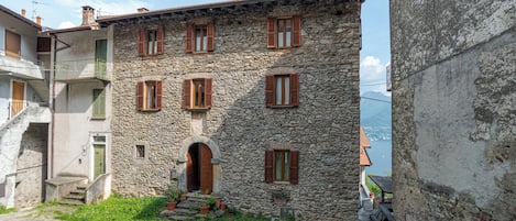 A stone building with multiple windows and a central entrance.