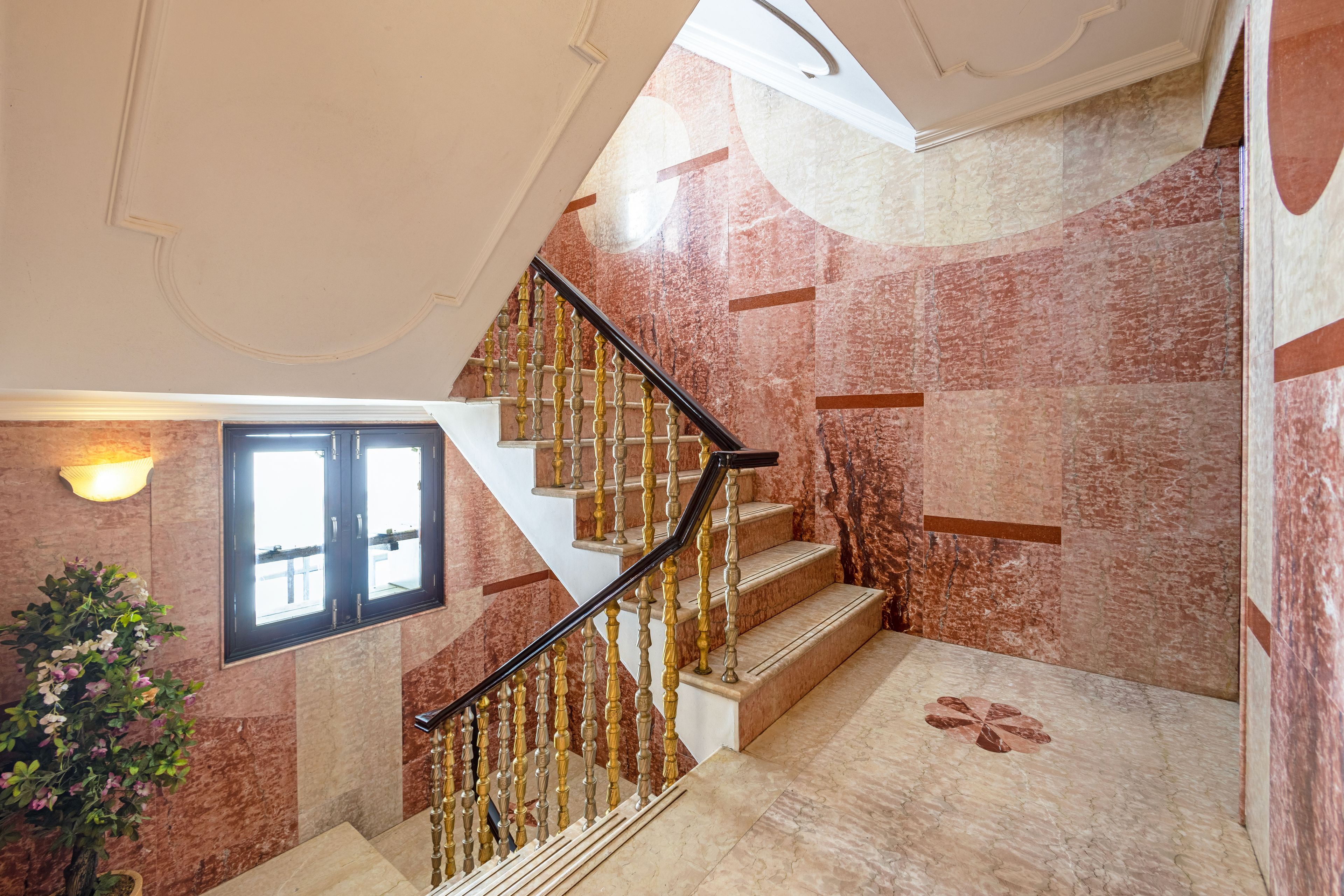 A staircase with marble walls and a handrail.