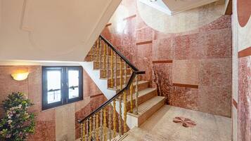 A staircase with marble walls and a handrail.