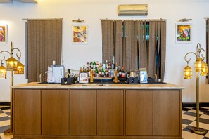 A bar area with a coffee machine, bottles, and a sign offering a discount.