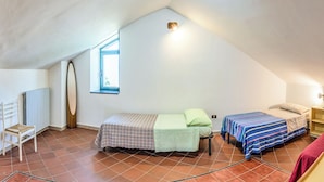 A dormitory room with two beds, a radiator, a window, and a desk. - Il Sentiero del Riccio (Sicignano degli Alburni)