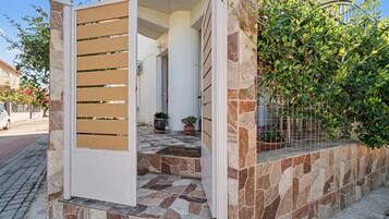 A gated entrance with a stone pathway leading to a building.