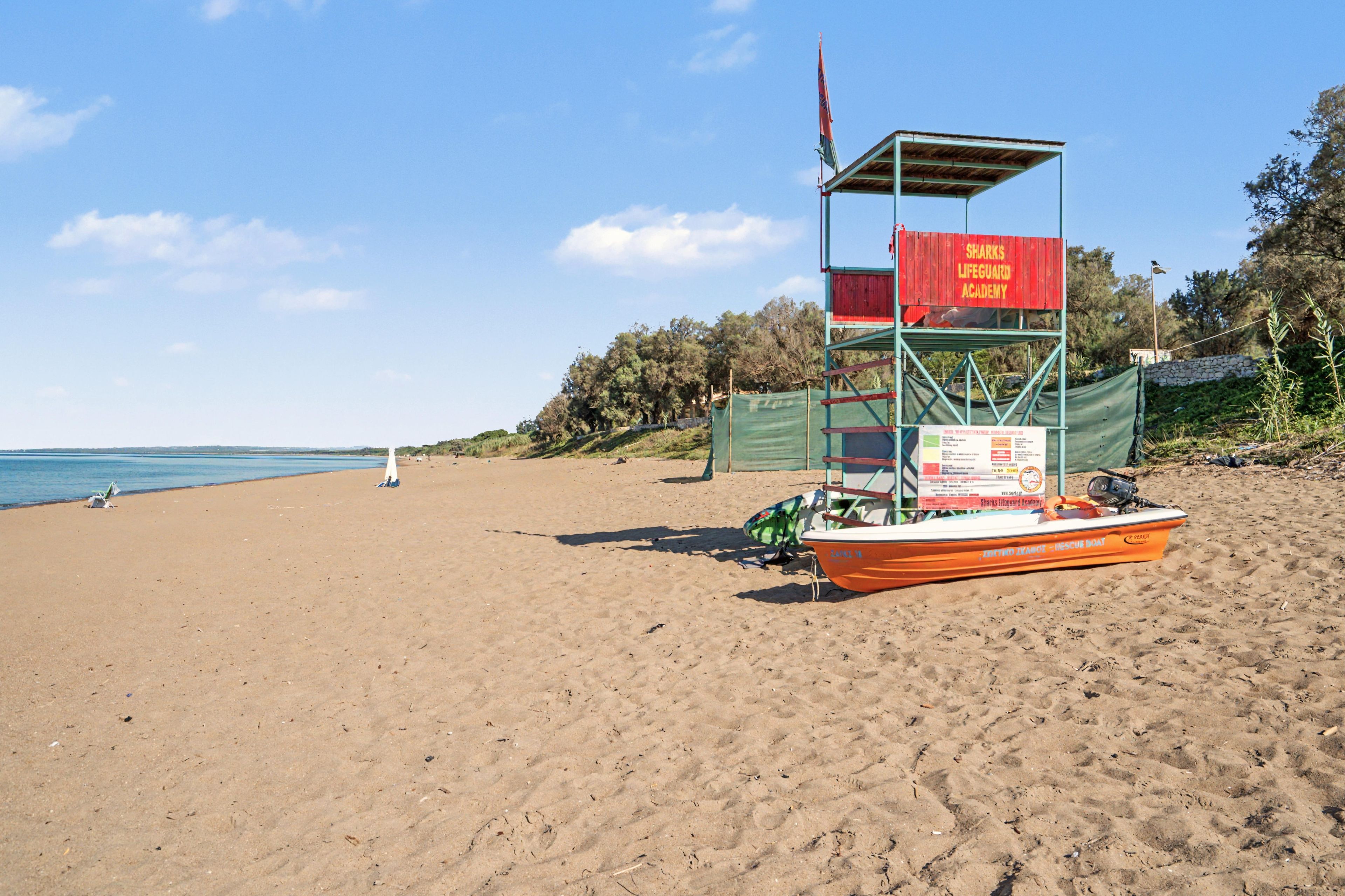 A lifeguard tower on a beach with a clear sky.