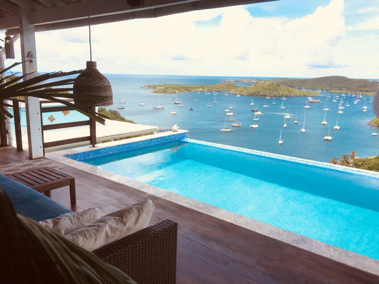 An infinity pool with a view of a marina.