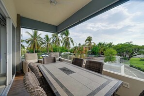 A balcony with a dining table and chairs, a ceiling fan, and a view of palm trees and a road. - 2-unit Combo w/ Resort Perks < 1 Mi to Beach! (Nuevo Nayarit)