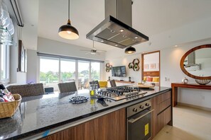 A modern kitchen with a large island, built-in oven, and stainless steel appliances. - Grand Marina Retreat 2-unit Combo w/ Resort Perks! (Nuevo Nayarit)