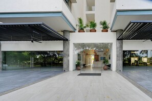 A modern building entrance with a glass facade, potted plants, and a reception desk. - Grand Marina Retreat 2-unit Combo w/ Resort Perks! (Nuevo Nayarit)