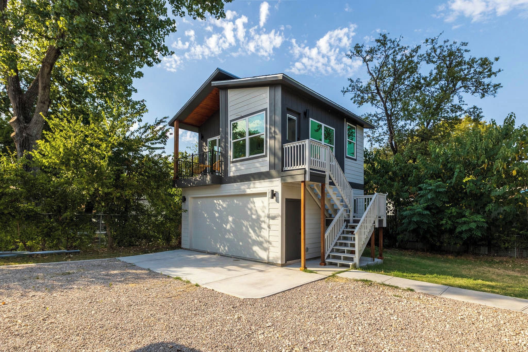 A two-story house with a front porch, a staircase, and a garage.