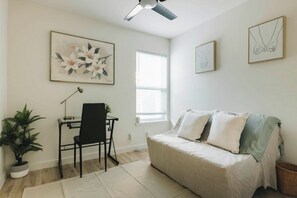 A bedroom with a bed, a desk with a chair, a window, and artwork on the walls. - 4 Mi to Downtown Austin! Quiet & Quaint Home (Austin)