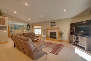 A living room with a fireplace, a television, and a sofa.