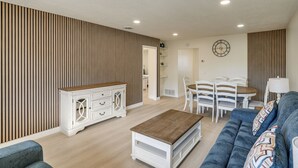 A modern living room with a sofa, coffee table, and dining area. - 1 Mi to Beach! Walkable Extended Base in Monterey (Monterey)