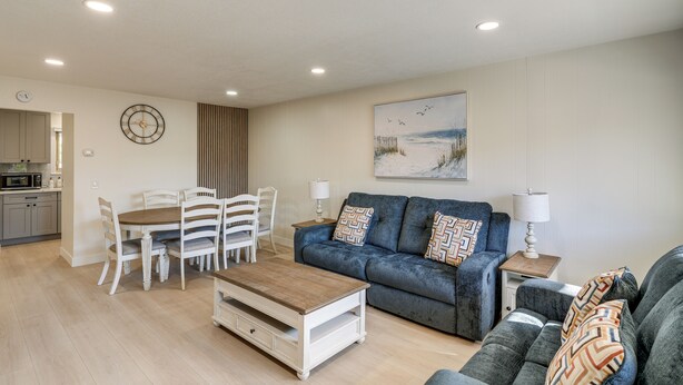 A modern living room with a dining area, a sofa set, a coffee table, and a painting on the wall. - 1 Mi to Beach! Walkable Extended Base in Monterey (Monterey)