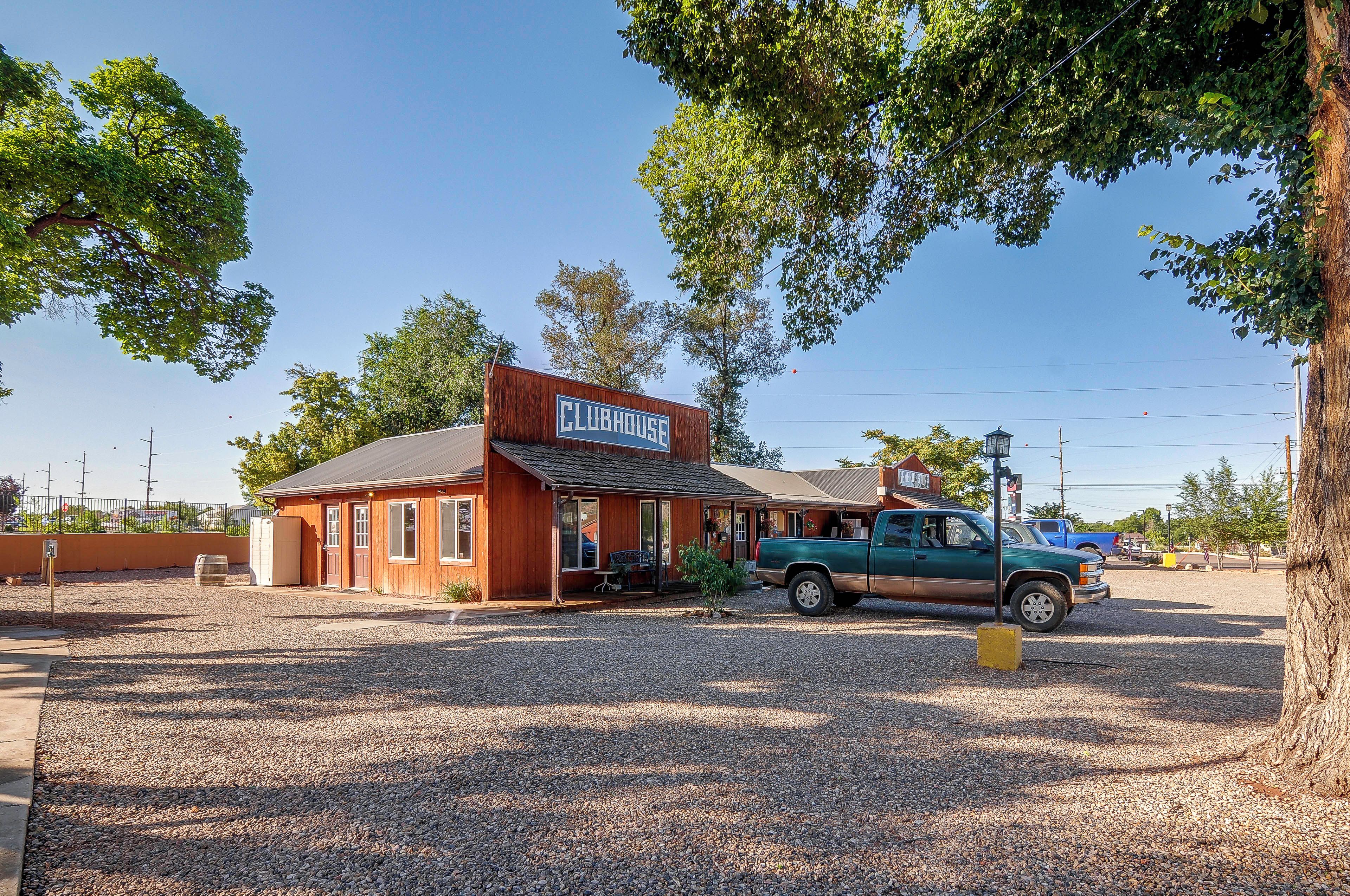 A building with a sign that reads 'CLUBHOUSE' and a parked truck in front.