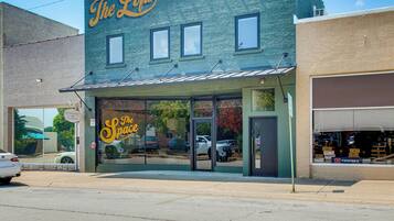 A building with a storefront labeled 'The Lifts' and a large glass window displaying 'The Space' sign.