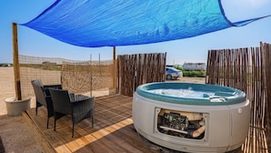 A hot tub on a wooden deck with a blue shade sail overhead. - Hot Tub, Picnic Area: RV Stay in Carlsbad (Carlsbad)