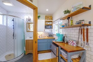 A modern kitchen with a built-in oven, microwave, and coffee maker.