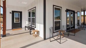 A modern building with large windows, a wooden bench, and a metal chair. - Private Pickleball Court! Family Glen Rose Getaway (Glen Rose)