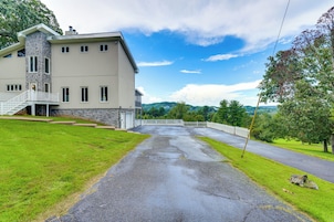 A large, two-story house with a stone facade and a covered porch.
