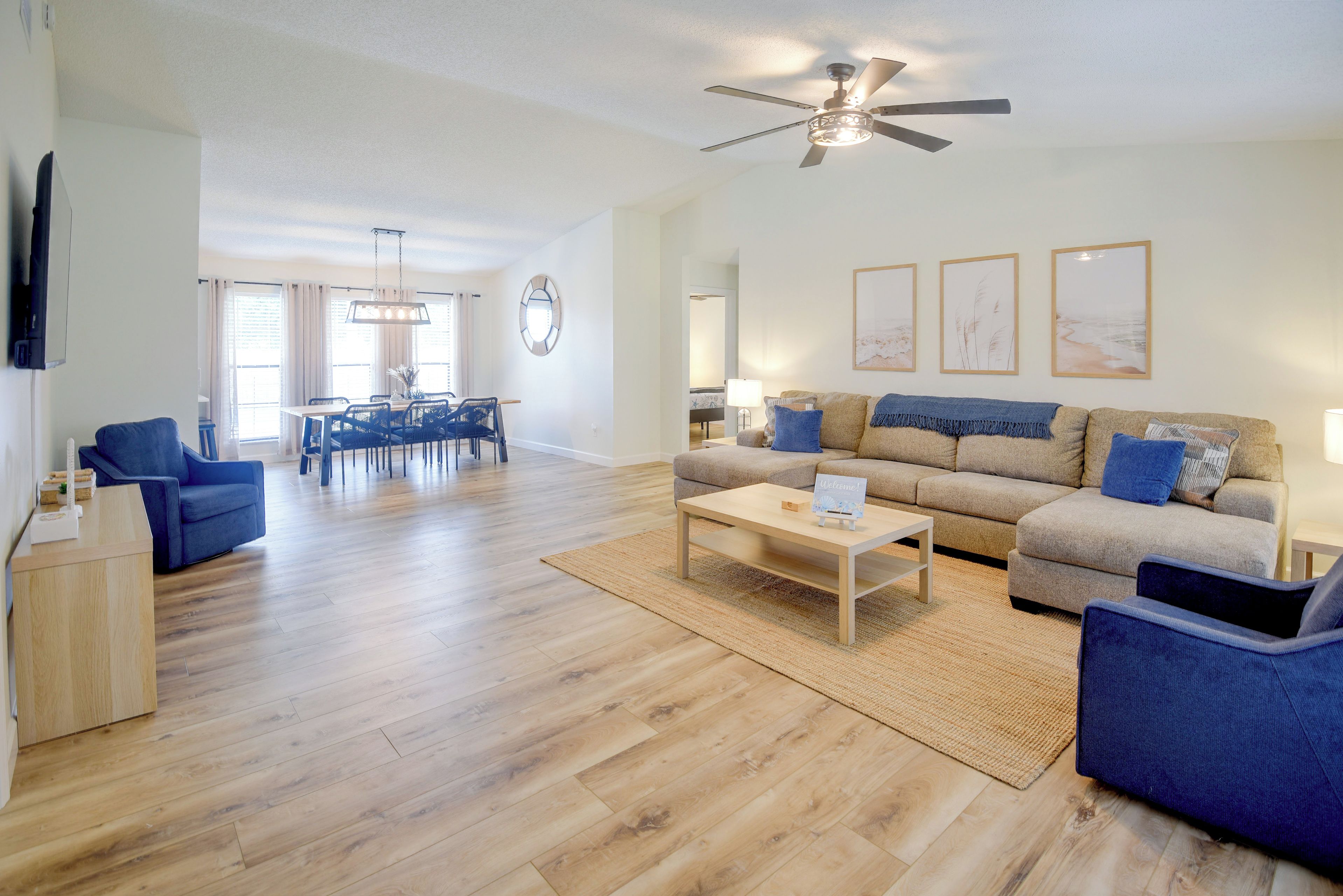 A spacious living area with a dining table, sofas, and a coffee table.