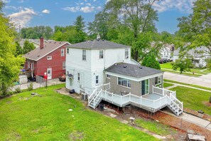 A two-story house with a front porch and a small attached garage.