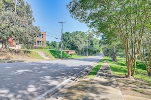 A quiet residential street with a two-story house, a sidewalk, and a grassy area. - Walk to Main St! Quaint Philadelphia Home w/ Yard (Philadelphia)