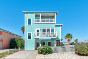 A two-story building with a balcony on the upper floor, a sign reading 'NO AGENDA HACIENDA,' and a year displayed as '2008.' - No Agenda Hacienda | Private Pool, Game Room, Close to Beach! (Port Aransas)