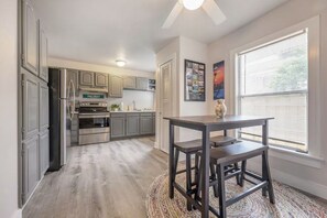 A modern kitchen with grey cabinets, a stainless steel refrigerator, and a built-in oven. - Entire rental 2 bed unit in St. Petersburg, Florida - PRIME LOCATION! (St. Petersburg)