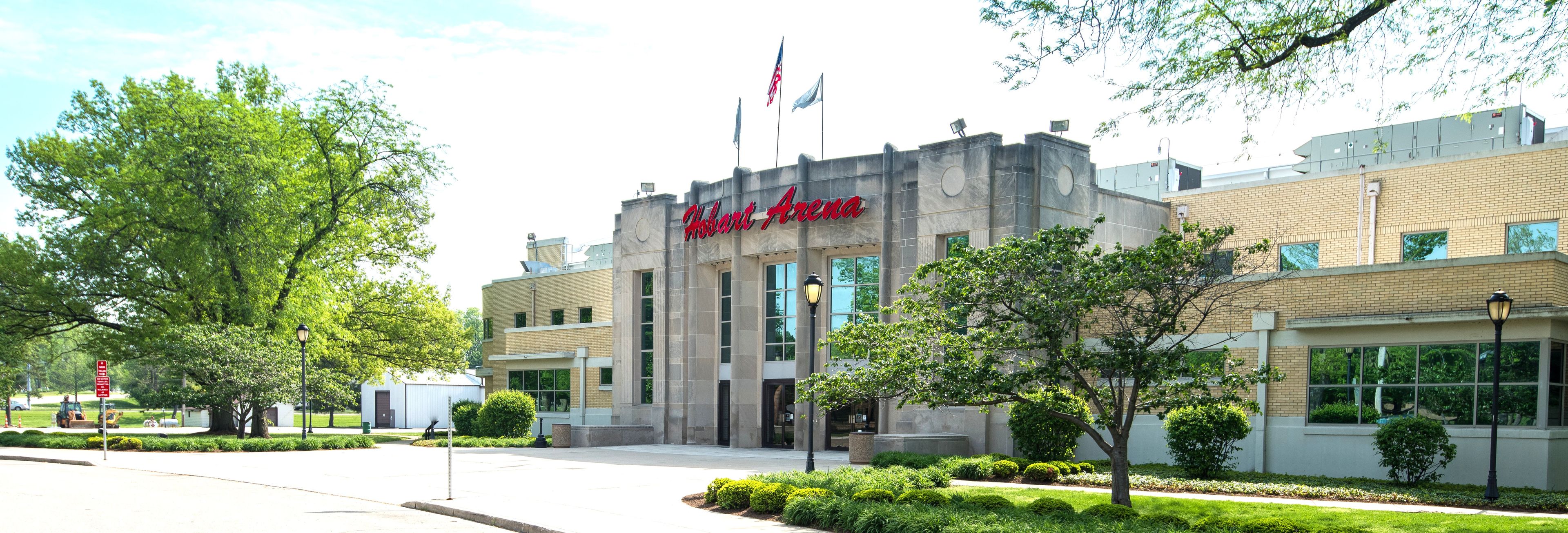Um edifício com uma placa indicando 'Hobart Arena' e um mastro com a bandeira americana.