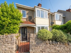 A two-story house with a stone wall, a satellite dish, and a gated entrance. - Court Hill Haven,
A wonderful base for your Swanage stay. (Swanage)