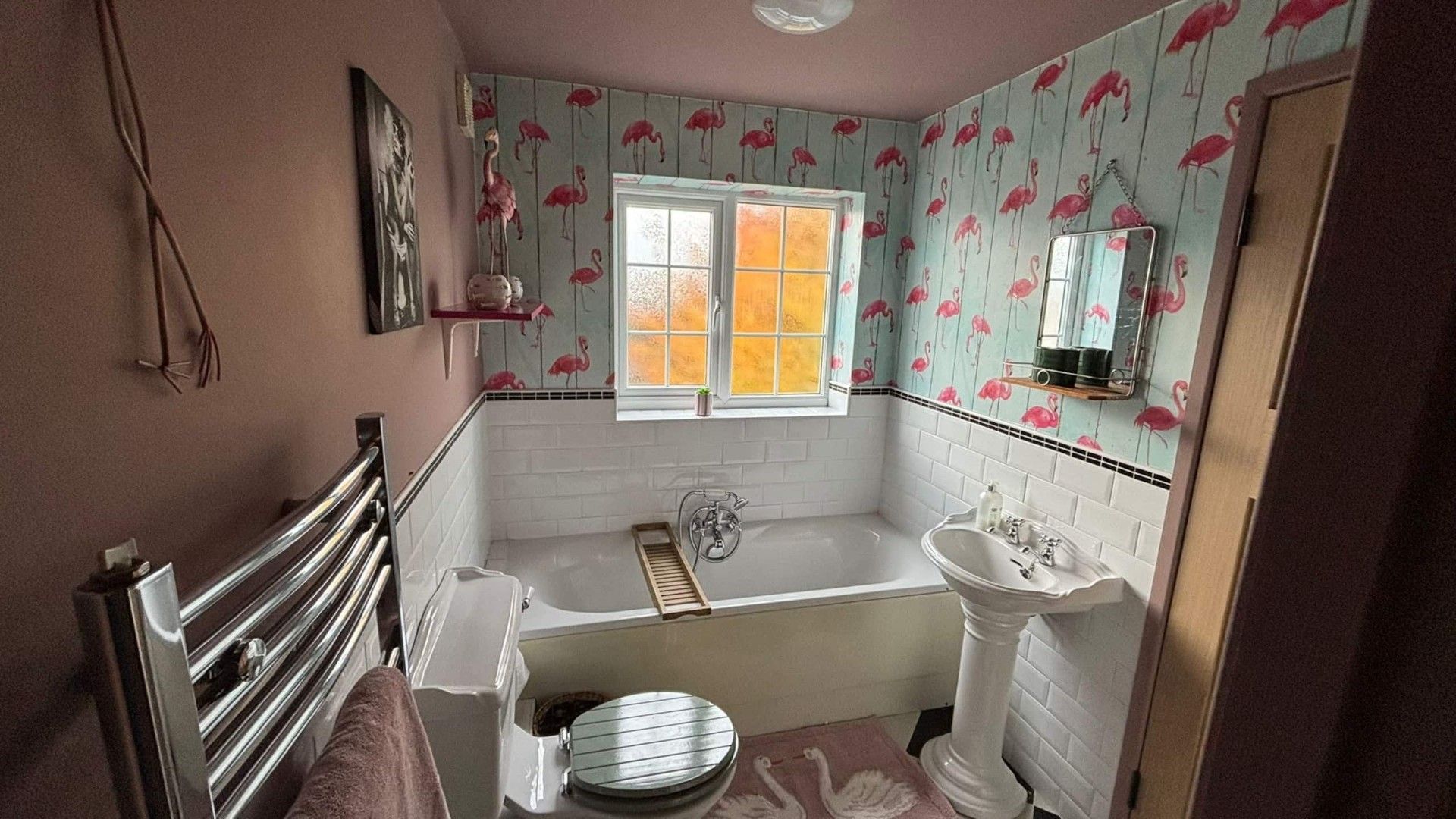 A bathroom with a bathtub, a sink, and a window.
