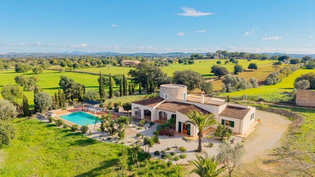 A villa with a swimming pool, surrounded by lush greenery and a view of distant hills. - Country House 'Son Bartolo' with Private Terrace, Wi-Fi and Air Conditioning (Inca)