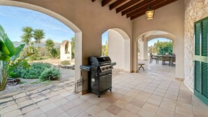 An outdoor patio with a barbecue grill, seating area, and views of a mountainous landscape. - Country House 'Son Bartolo' with Private Terrace, Wi-Fi and Air Conditioning (Inca)