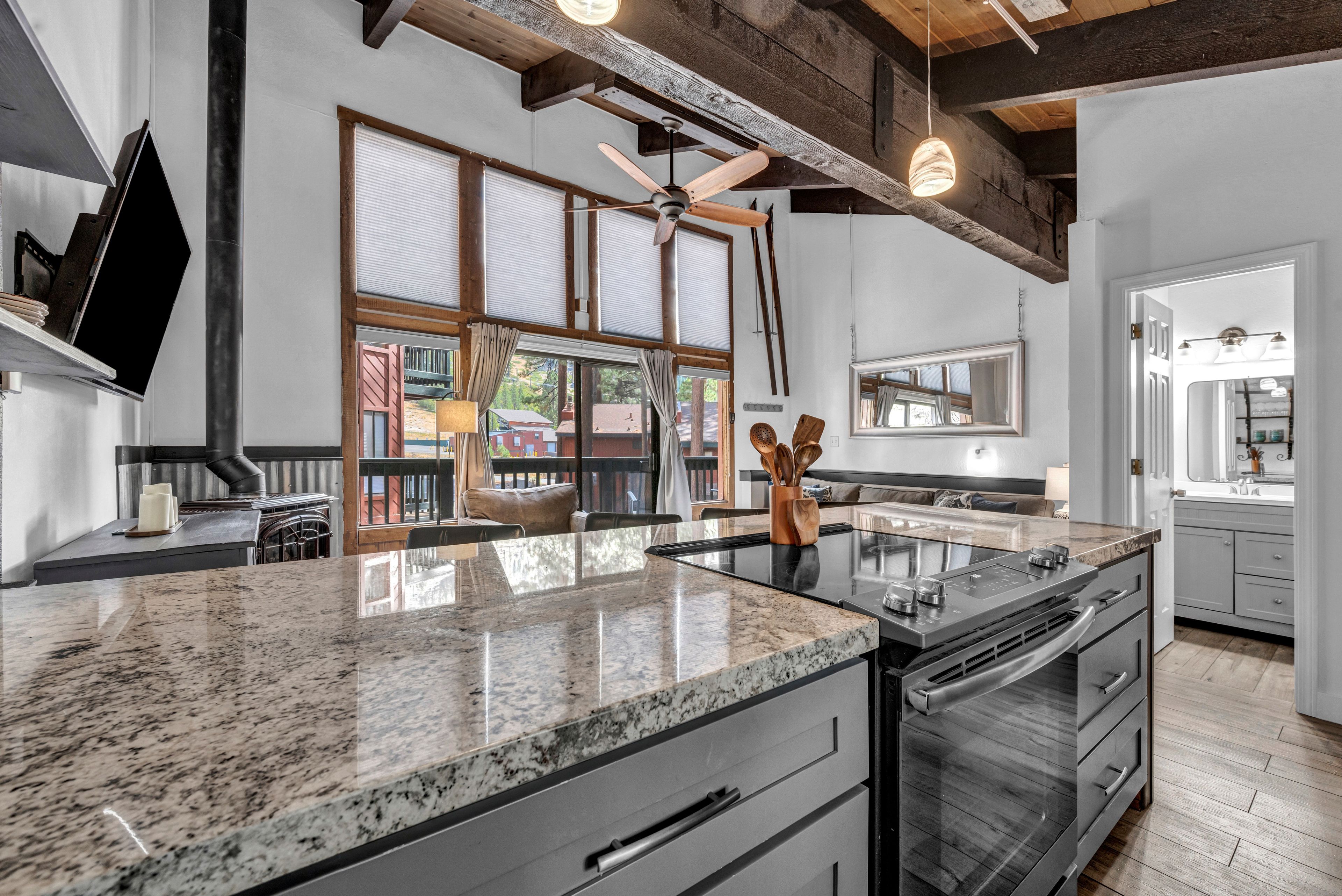 A modern kitchen with granite countertops, stainless steel appliances, and a large island.