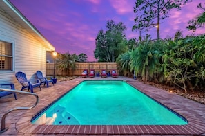 A rectangular swimming pool with a brick border, surrounded by lounge chairs and a wooden fence. - New Discount! Mayo Retreat, Pool, Close to Beach (Jacksonville)