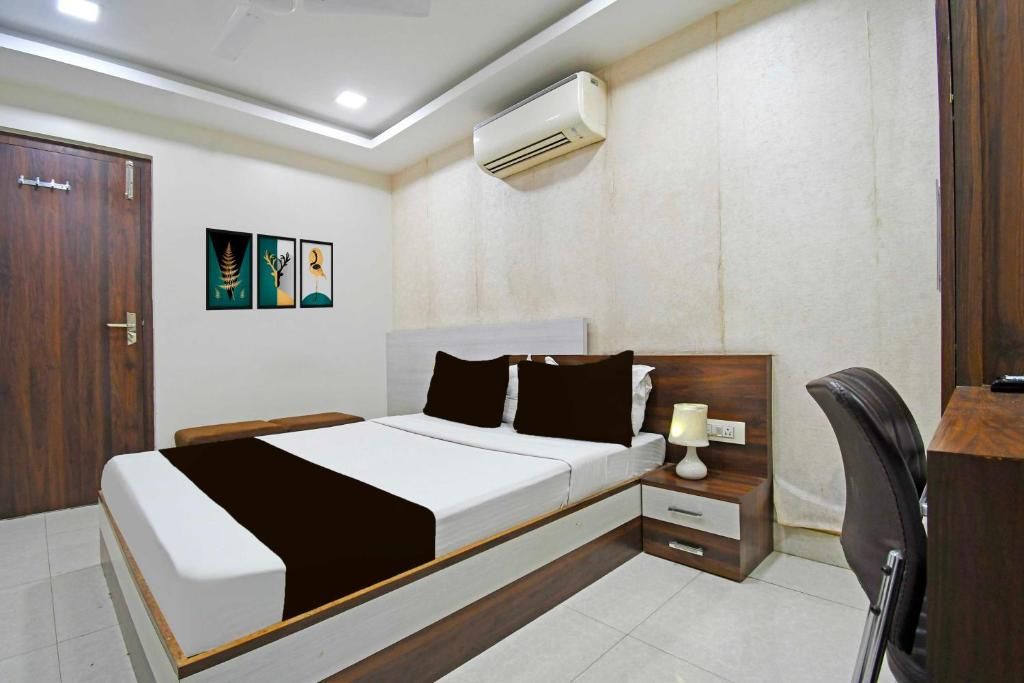 A modern bedroom with a bed, bedside table, and a desk.