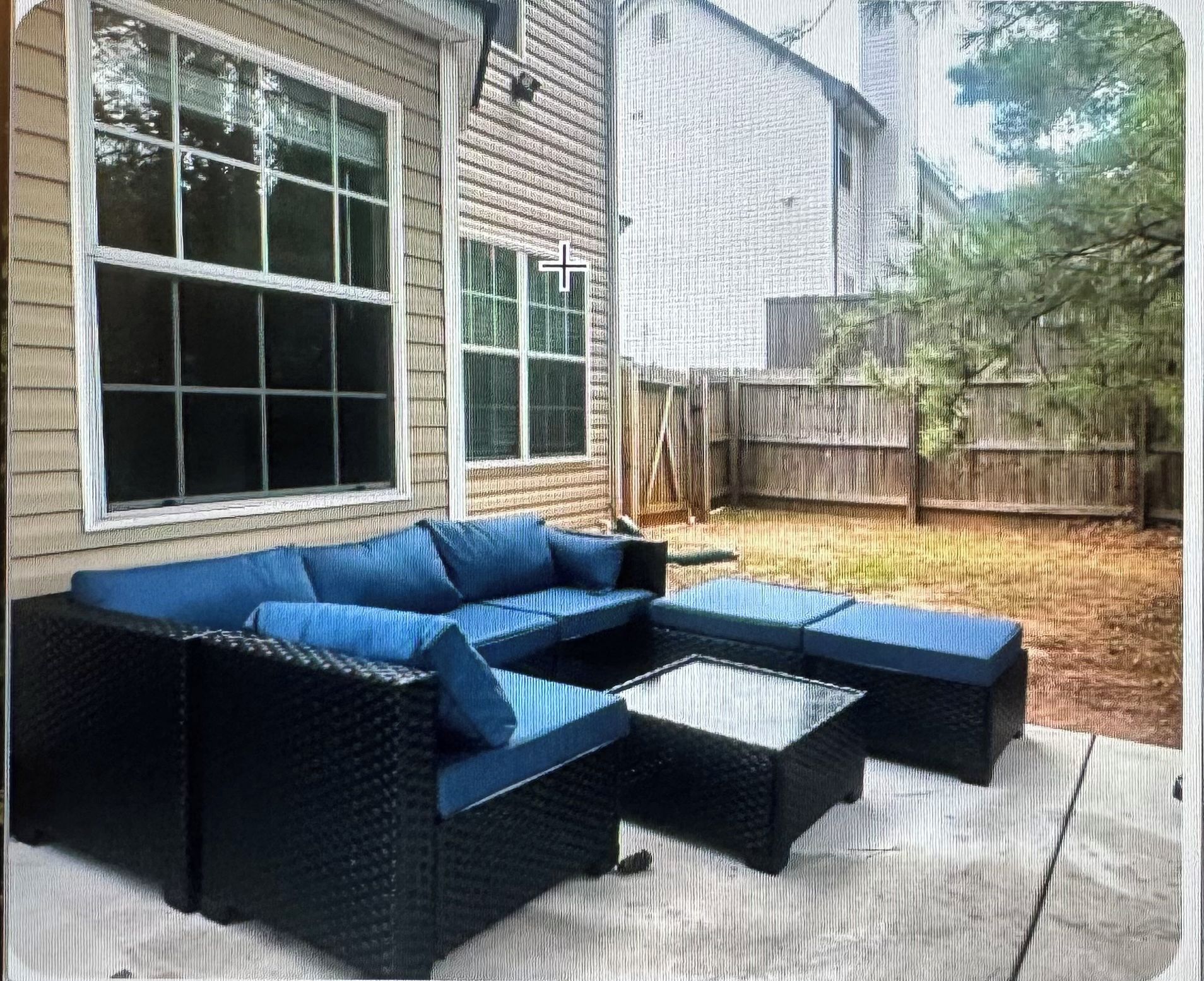 A sectional sofa with a low-profile design, positioned on a wooden deck.
