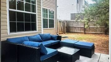 A sectional sofa with a low-profile design, positioned on a wooden deck.