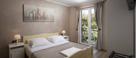 A hotel room with a bed, two bedside tables with lamps, a painting on the wall, a window with curtains, and a chair.