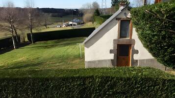 A small, single-story building with a sloped roof, a door, and a window.