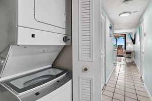 A laundry room with a Kenmore dryer and a hallway leading to a bathroom with a view of the ocean. - 🌴Stunning Gulf Views | Pool | Jetty East 117A🌴 (Destin)