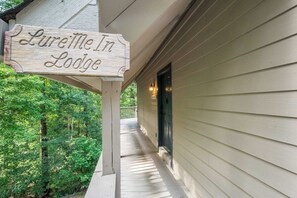 A wooden sign with the text 'Lurabelle In Lodge' mounted on a porch railing. - Lake Lure Area Retreat with Hot Tub and Game Room (Rutherfordton)