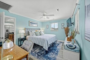 A bedroom with a bed, a desk, a chair, a ceiling fan, and a window. - Footprints in the Sand - Channel Home w/Swim Spa (North Myrtle Beach)