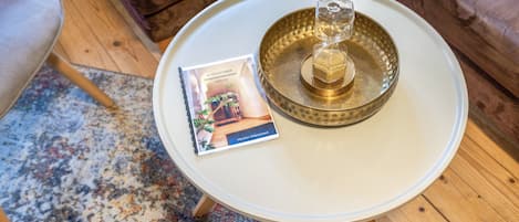 A round table with a book and a decorative glass object.