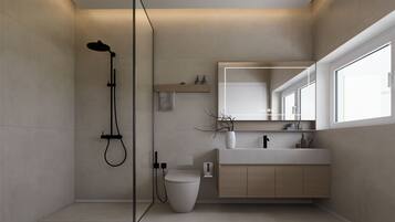 Ein modernes Badezimmer mit Dusche, Toilette und Waschtisch.
