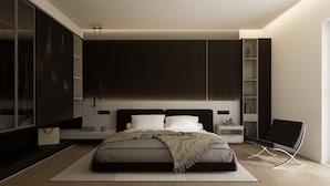Un dormitorio moderno con cama, mesitas de noche, armario y una silla.