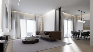 Una sala de estar moderna con un sofá, una mesa de centro y un comedor con sillas.