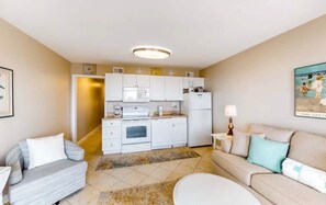 A compact living space with a kitchenette, two sofas, and a painting on the wall. - Gulf Shores Plantation 3202 Gulf Front Resort (Baldwin County)