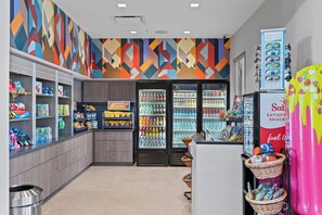 A snack bar with shelves stocked with snacks, a beverage cooler, and a fuel station. - 5BR Villa Near Disney, Universal & SeaWorld! (Orlando)