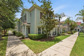 A residential street with houses, sidewalks, and greenery. - West Lucaya 4BR Home Near Disney & Parks (Kissimmee)