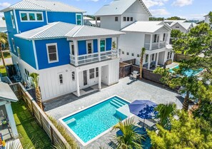 A multi-story residential building with a swimming pool and outdoor seating area. - Blue Lagoon: Private beach access, FREE Golf cart, Heated pool, Arcade Room (Miramar Beach)